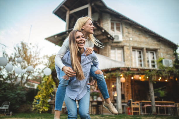 istock Playful girlfriends having a great time in a front yard 1061873548