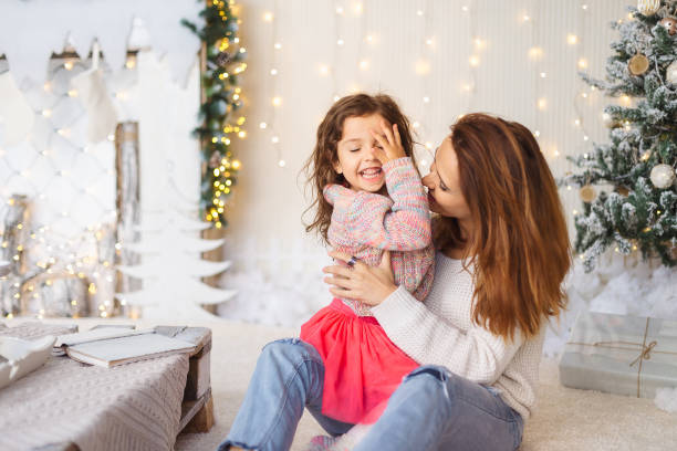 istock Young mom having fun with her daughter on Christmas eve 1061875946