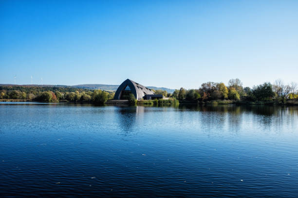 Haff Reimech pond view Remerschen, Luxembourg - October 15, 2018: Panoramic view of the lake in the nature reserve Haff Reimech and ornithology center Biodiversum in Remerschen near Schengen, Luxembourg. Nature and bird protection concept. remich stock pictures, royalty-free photos & images
