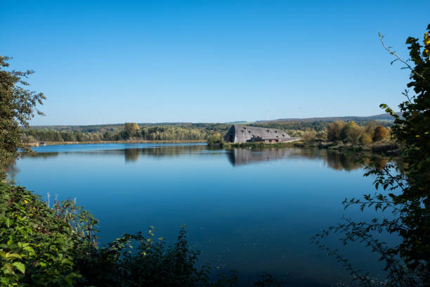 Haff Reimech pond view Remerschen, Luxembourg - October 15, 2018: Panoramic view of the lake in the nature reserve Haff Reimech and ornithology center Biodiversum in Remerschen near Schengen, Luxembourg. Nature and bird protection concept. remich stock pictures, royalty-free photos & images