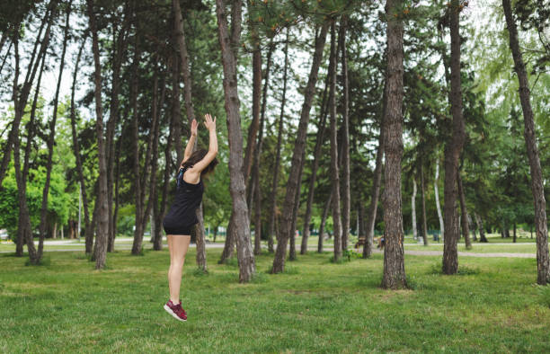 Woman exercising in a public park Young woman doing front handspring in recreational park handspring stock pictures, royalty-free photos & images
