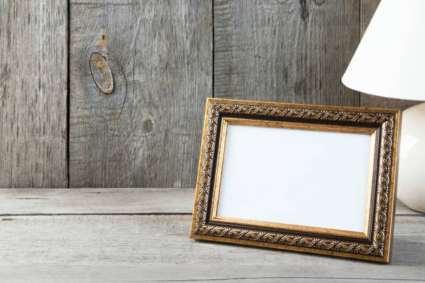 istock Empty picture frame on wooden background. 1061877616