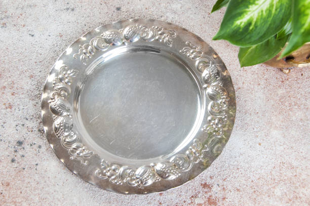 istock Vintage silverplate dish and green plants 1061877674