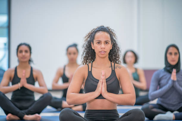 istock A young women sits in a yoga pose 1061886468