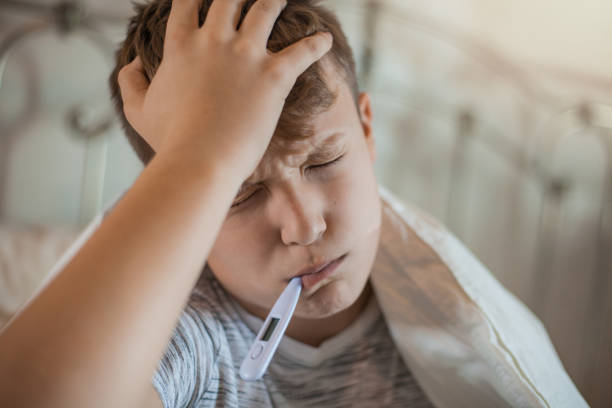 istock Boy With a Thermometer in His Mouth 1061889878