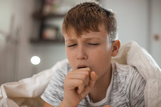 Boy Coughing stock photo
