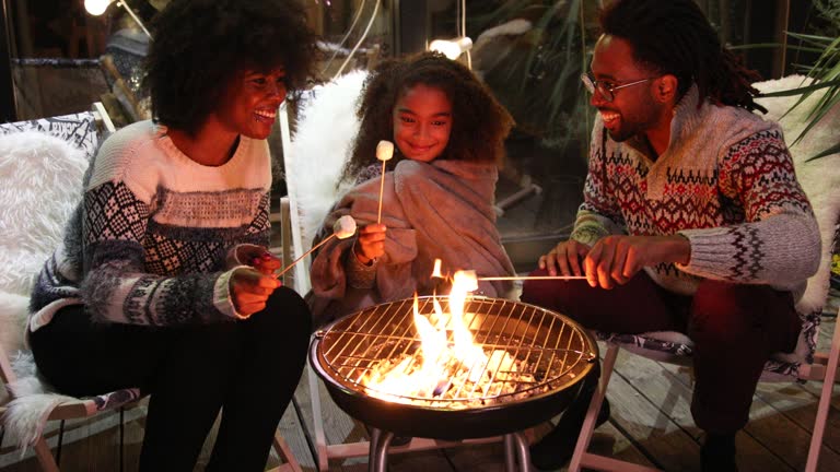 Family on porch making roasted marshmallowFamily on porch making roasted marshmallow