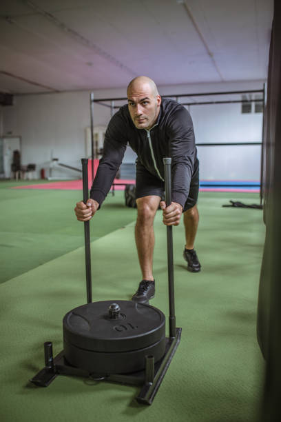 istock Muscular Fit Man Exercising in a Gym 1061892340