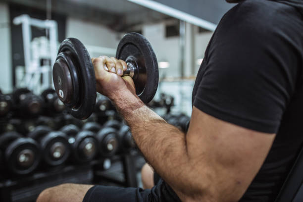 istock Muscular Fit Man Exercising in a Gym 1061892458