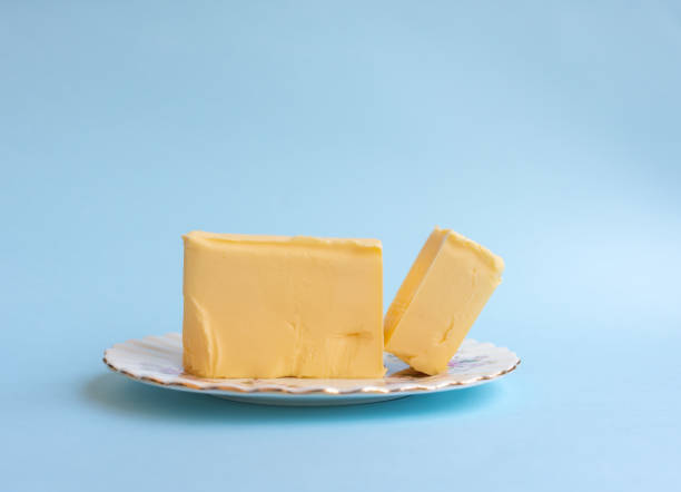 istock Organic butter on vintage plate against blue background 1061898126