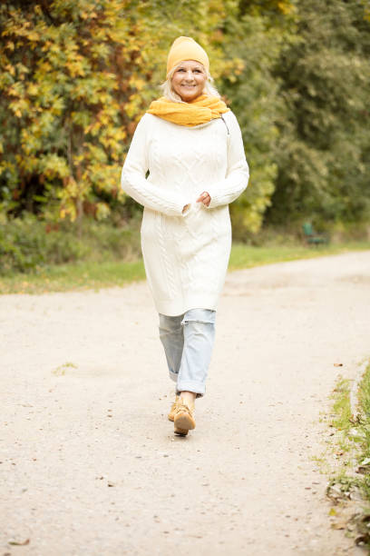 istock Senior woman in autumn park. 1061900098