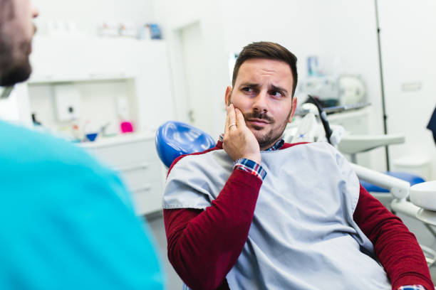 Dental treatment Young good looking man having dental treatment at dentist's office. human teeth stock pictures, royalty-free photos & images