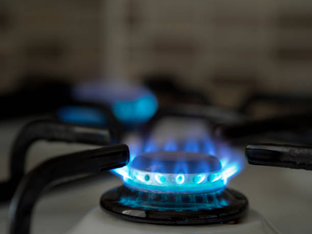 istock left open oven gas in the home kitchen. close-up blue colored burning gas 1061900538