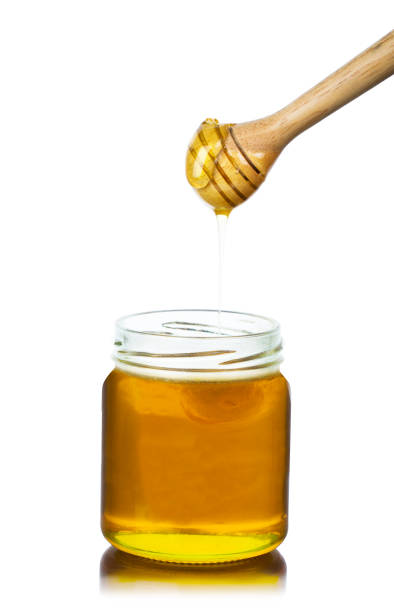 istock Honey dripping with Wooden sticks on a white 1061911990