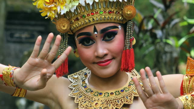 Young Balinese dancer performing Barong dance in a Hindu temple