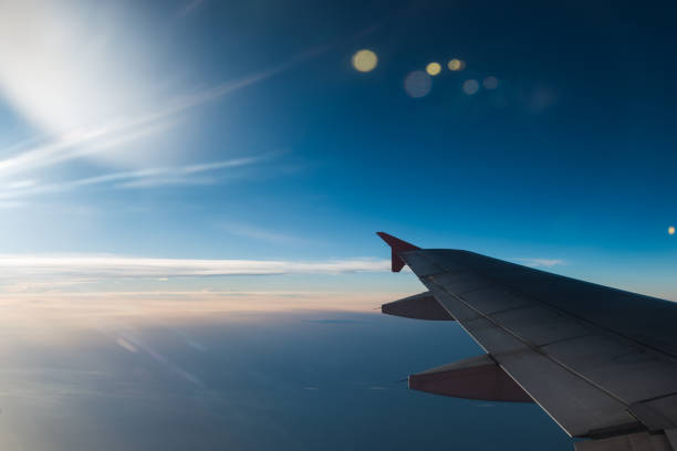 istock The plane is flying through the sunset sky 1061915908