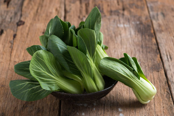 istock Pak Choy, fresh chinese cabbage on wood background 1061915928
