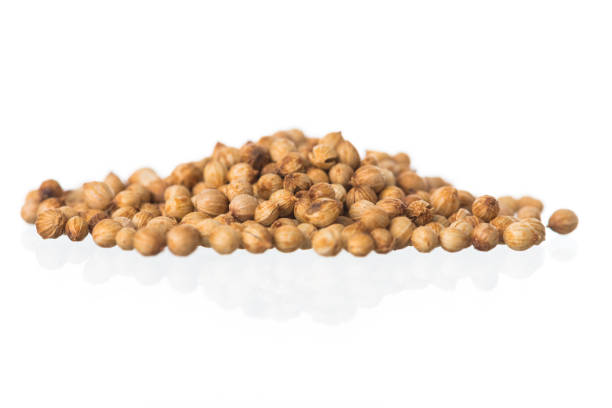 istock Pile of coriander seeds on white background 1061915942