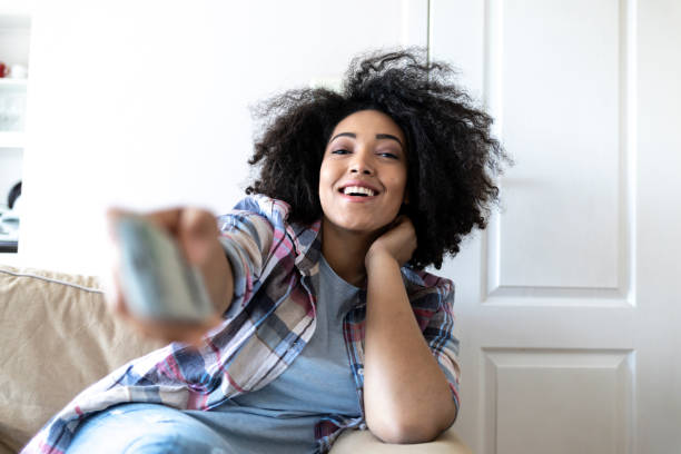istock Woman sitting at home and watching TV 1061916246