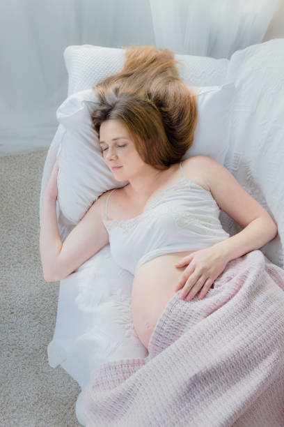 istock young pregnant woman sleeping on sofa - day nap 1061917008