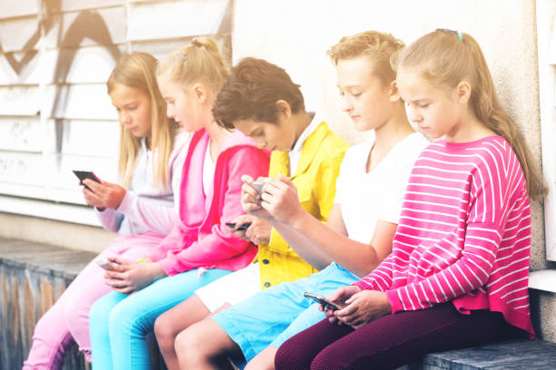 istock Cheerful children are chatting on their smartphone 1061918610