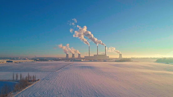 The bad ecology. The thermal power plant near by big city in the cold winter's day. Sukharevo district, Minsk, Belarus, Eastern Europe. Aerial drone photo