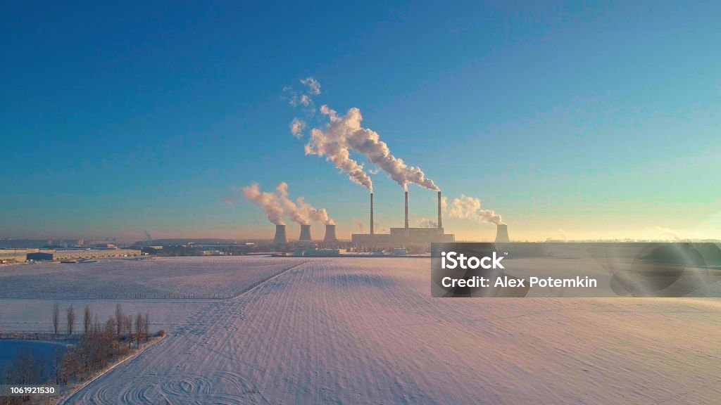 The bad ecology. The thermal power plant near by big city in the cold winter's day. Aerial drone photo The bad ecology. The thermal power plant near by big city in the cold winter's day. Sukharevo district, Minsk, Belarus, Eastern Europe. Aerial drone photo Smoke Stack Stock Photo