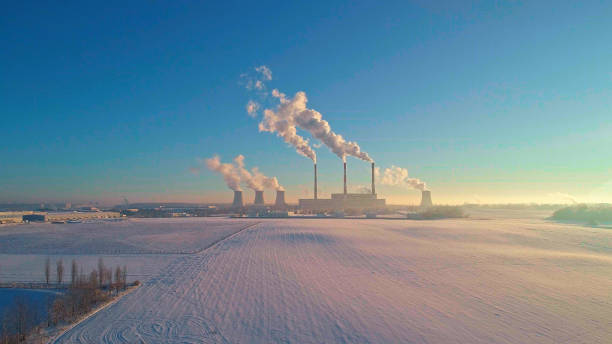 The bad ecology. The thermal power plant near by big city in the cold winter's day. Aerial drone photo The bad ecology. The thermal power plant near by big city in the cold winter's day. Sukharevo district, Minsk, Belarus, Eastern Europe. Aerial drone photo minsk photos stock pictures, royalty-free photos & images