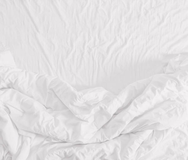 Comfortable bedroom,messy bedding sheets and duvet top view stock photo