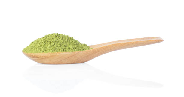istock green tea powder with wooden spoon isolated on white 1061941592