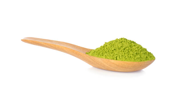 istock Matcha green tea powdered with wooden spoon isolated on white 1061941642