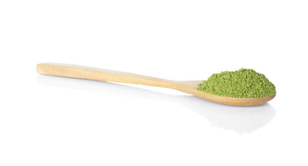 istock Matcha green tea powdered with wooden spoon isolated on white 1061941646