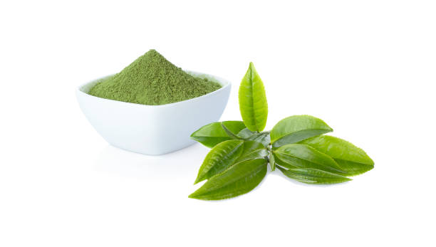 Green tea powder in cup with green tea leaf on white Green tea powder in cup with green tea leaf on white background, clipping path matcha tea photos stock pictures, royalty-free photos & images