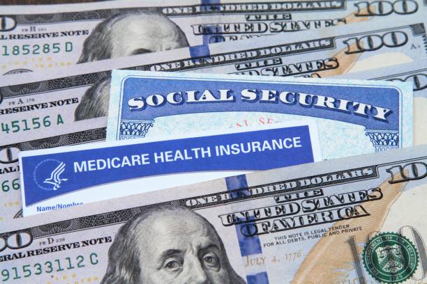 Medicare and Social Security cards with cash Medicare and Social Security cards with USA currency. Health care and social welfare concept for seniors in the USA. Essential senior ID's. social security social security card identity us currency stock pictures, royalty-free photos & images