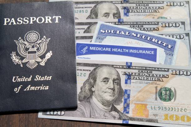 Medicare and Social Security cards with USA passport and currency Medicare and Social Security cards with USA Passport and currency. Health care and social welfare concept for seniors in the USA. Essential American ID's. social security social security card identity us currency stock pictures, royalty-free photos & images