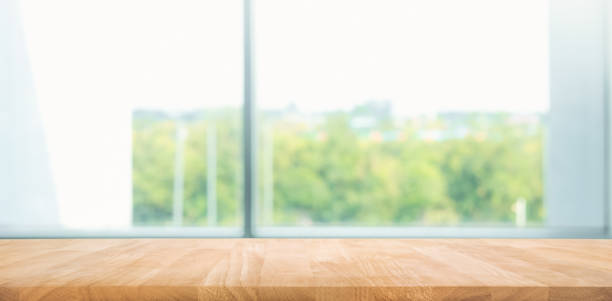 istock Empty wood table with blur  window view background.For montage product display or design key visual 1061944560
