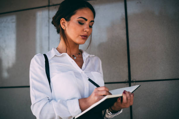 istock Charming businesswoman taking notes during a working day 1061948428