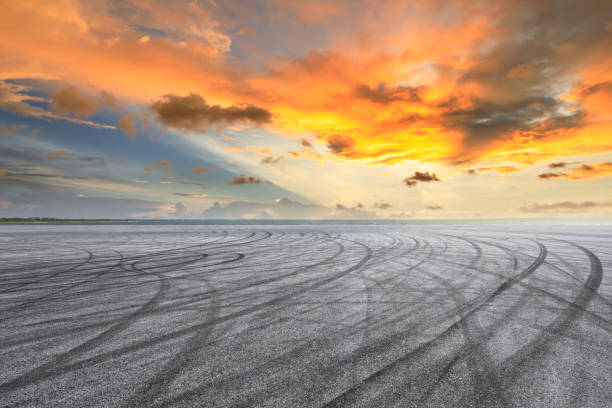 istock Circuit road and dramatic sky with coastline at sunset 1061951412