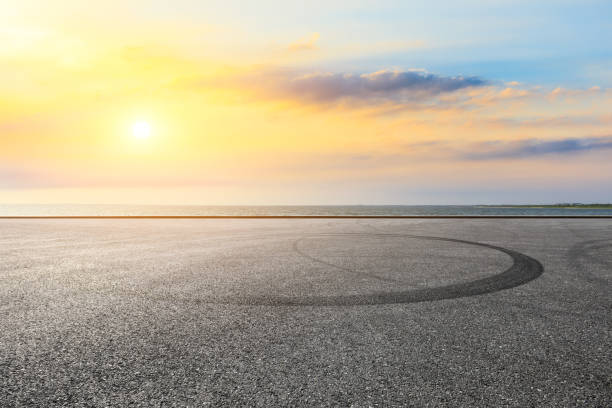 istock Circuit road and dramatic sky with coastline at sunset 1061951806