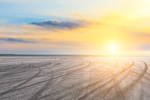 istock Circuit road and dramatic sky with coastline at sunset 1061952046