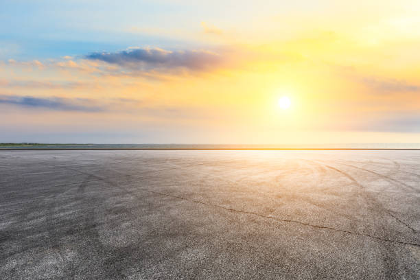 istock Circuit road and dramatic sky with coastline at sunset 1061952050
