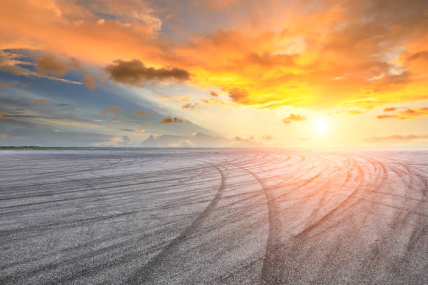istock Circuit road and dramatic sky with coastline at sunset 1061953192