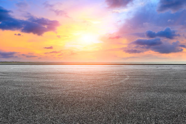 istock Circuit road and dramatic sky with coastline at sunset 1061953670