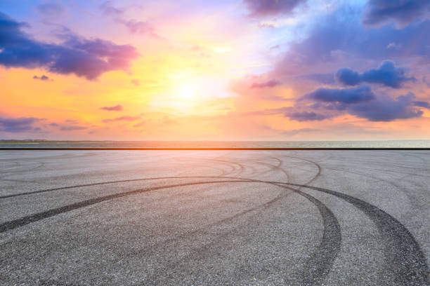 istock Circuit road and dramatic sky with coastline at sunset 1061953828