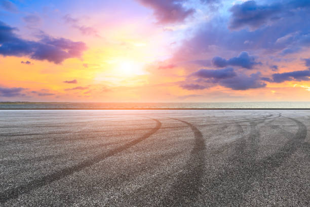 istock Circuit road and dramatic sky with coastline at sunset 1061953916