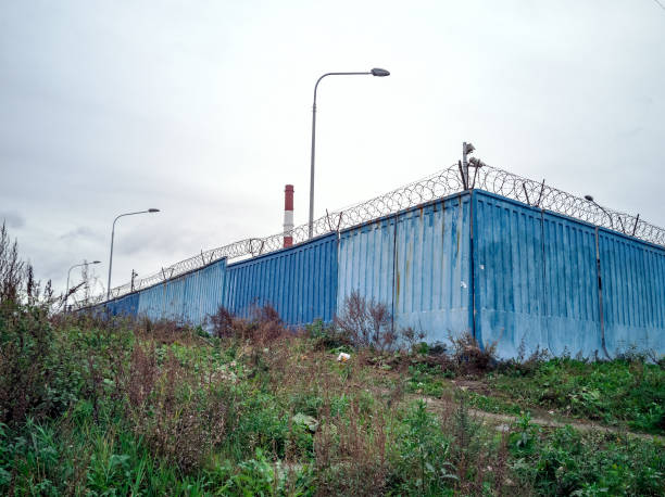 istock Barbed wire concrete wall. fence 1061964740