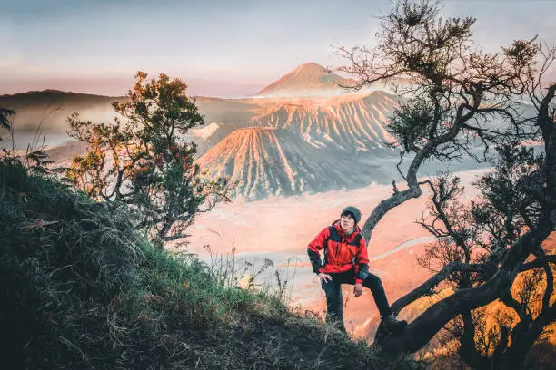 Traveler man with sunrise at volcano Mt.Bromo (Gunung Bromo) Kingkong hill East Java,Indonesia
