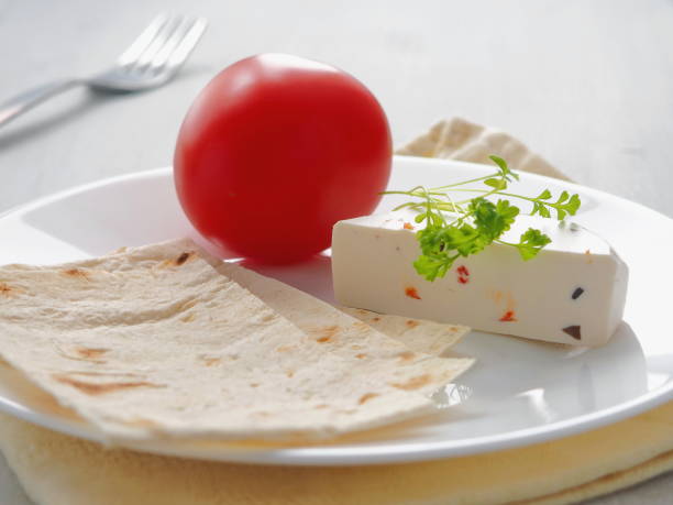 White plate with soft cheese, cress salad and pita bread on white plate. Healthy eating concept. stock photo