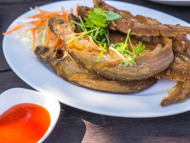 istock Fried fish with vegetables and chili sauce 1061982596