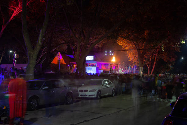 Many people walking along Waverley str. in Palo Alto on Halloween night. California, USA. 10/31/2018